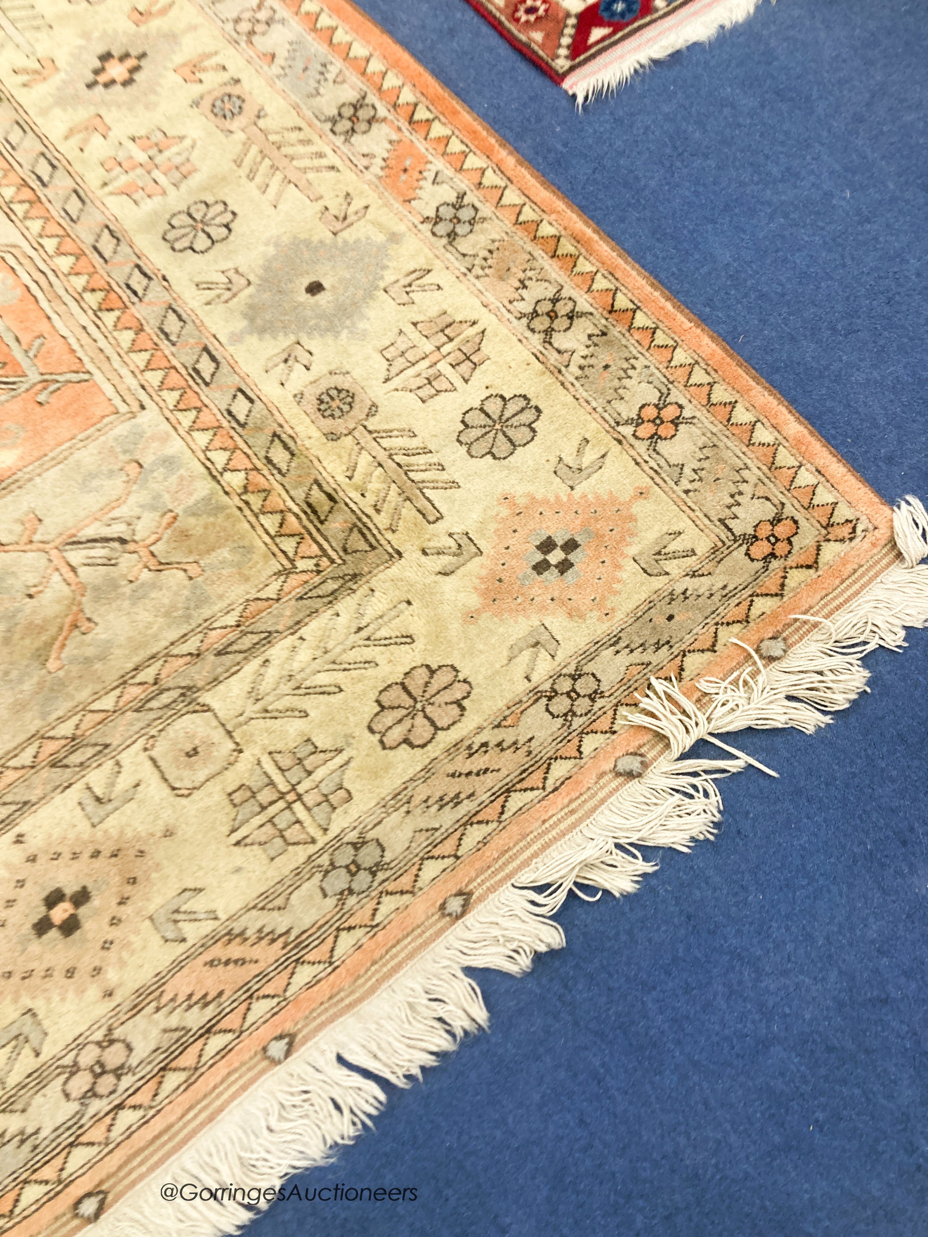 A large Caucasian Turkish design fawn ground carpet, 420 x 300cm